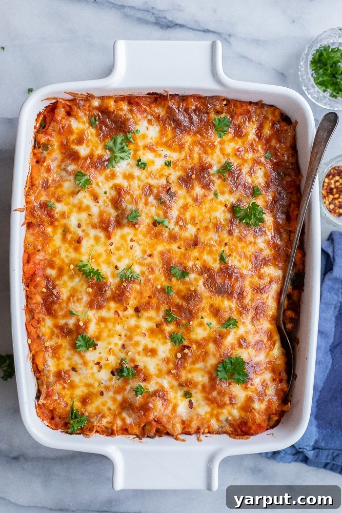 Veggie Pizza Bake with White Beans and Rice 6 Baked vegetarian pizza casserole with white beans and rice in a ceramic dish, garnished with fresh herbs and ready to serve