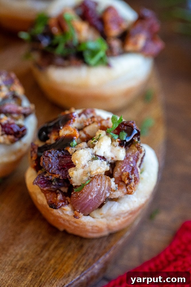 Caramelized Balsamic Onion and Goat Cheese Puffs 7 A close-up shot of a vegetarian holiday puff pastry bite, highlighting its festive colors and textures.