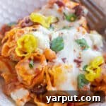 Mediterranean Tortellini Bake in a small bowl with parsley garnish