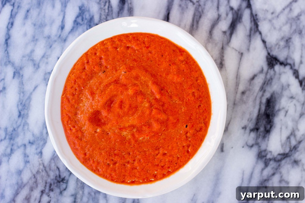 Homemade Gluten Free Vegan Roasted Red Pepper Enchilada Sauce 8 Homemade roasted red pepper enchilada sauce simmering in a pot