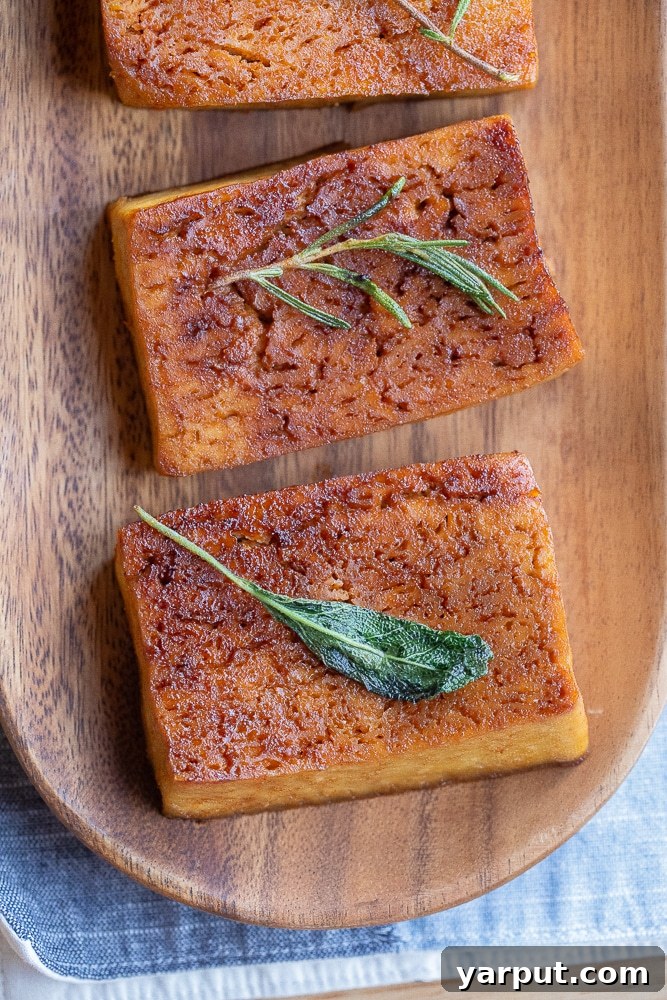 Buttery Garlic Herb Tofu Steaks 7 A stunning arrangement of garlic herb butter tofu steaks artfully placed on a rustic wooden platter, ready to be served