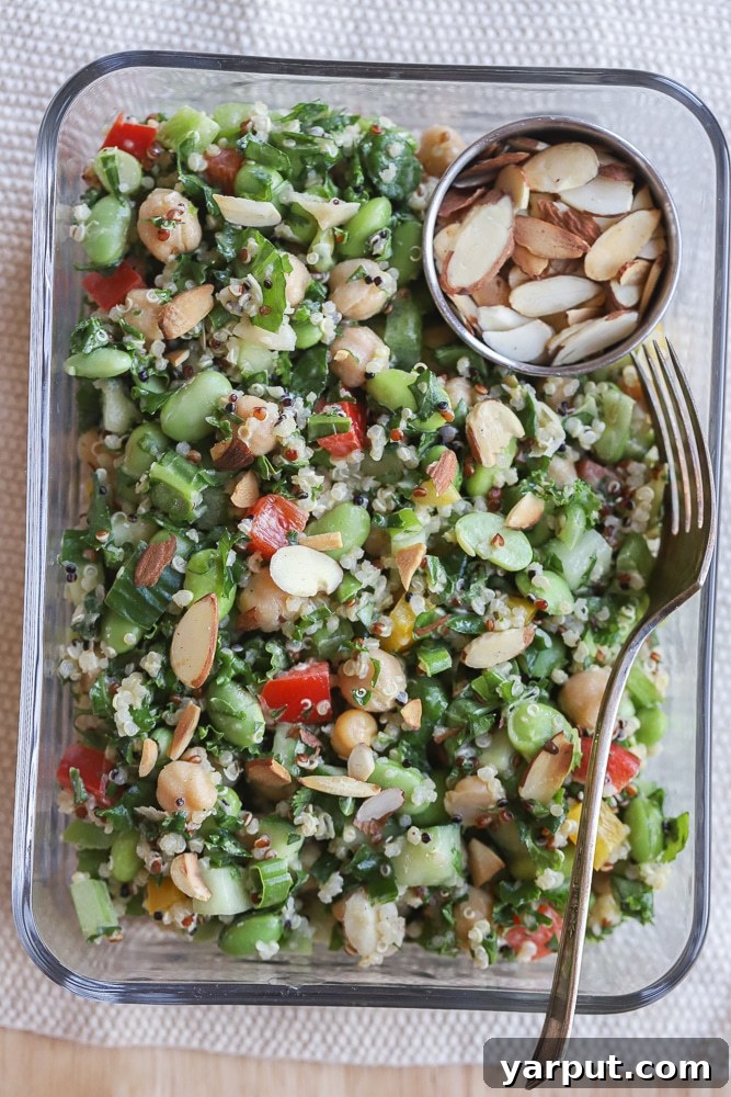 close up of a vibrant chickpea edamame salad in a meal prep container, ready to eat