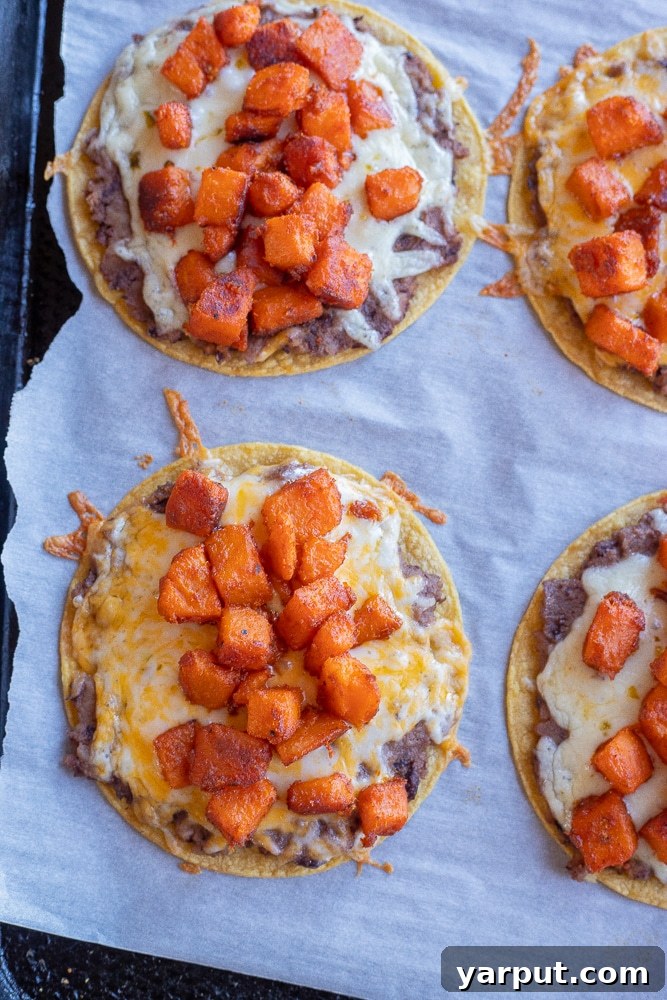 Roasted Sweet Potato Tacos 6 cheesy sweet potato tacos on a sheet pan after they have been baked in the oven