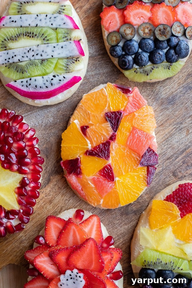 Close-up of brightly colored Fruit Tart Easter Egg Cookies adorned with fresh fruit and creamy mascarpone cheese, ready for an Easter celebration.