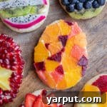 A finished Fruit Tart Easter Egg Cookie with fresh fruit and mascarpone cream.