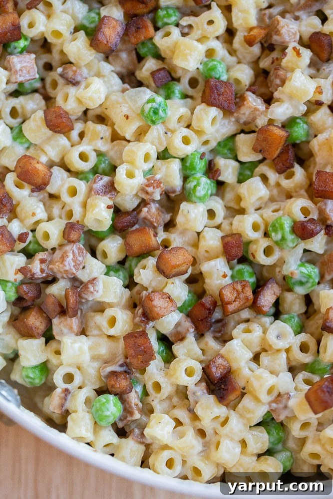 Vegetarian Pasta with Peas and Smokey Veggie Pancetta 6 Vegetarian pasta with peas and 'pancetta' served directly from a skillet, showcasing its rustic appeal and enticing textures.