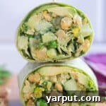 close up of a green goddess chickpea wrap cut in half and stacked on eachother