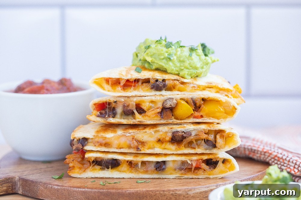 Sizzling Fajita Rice & Bean Quesadillas 5 horizontal photo of a stack of rice and bean quesadillas