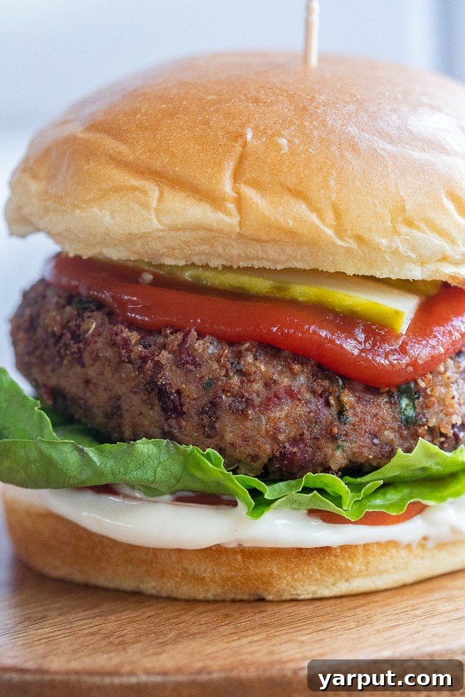 A high-protein kidney bean burger presented attractively on a plate with fresh garnishes.