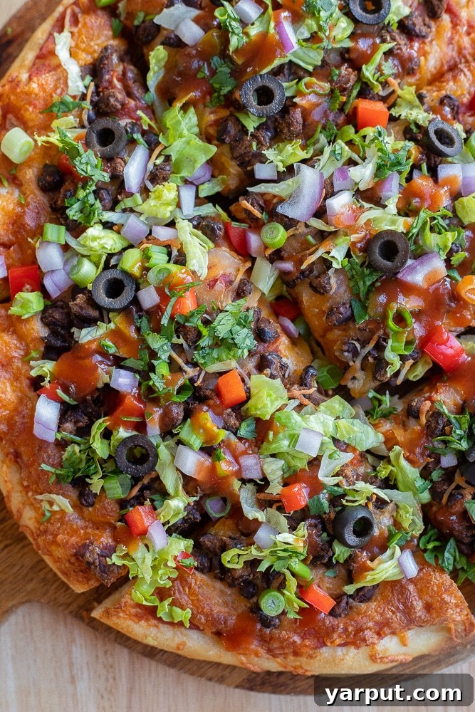 Savor the Crunch: Vegetarian Taco Pizza with Crispy Black Beans 6 close up of taco pizza loaded with toppings