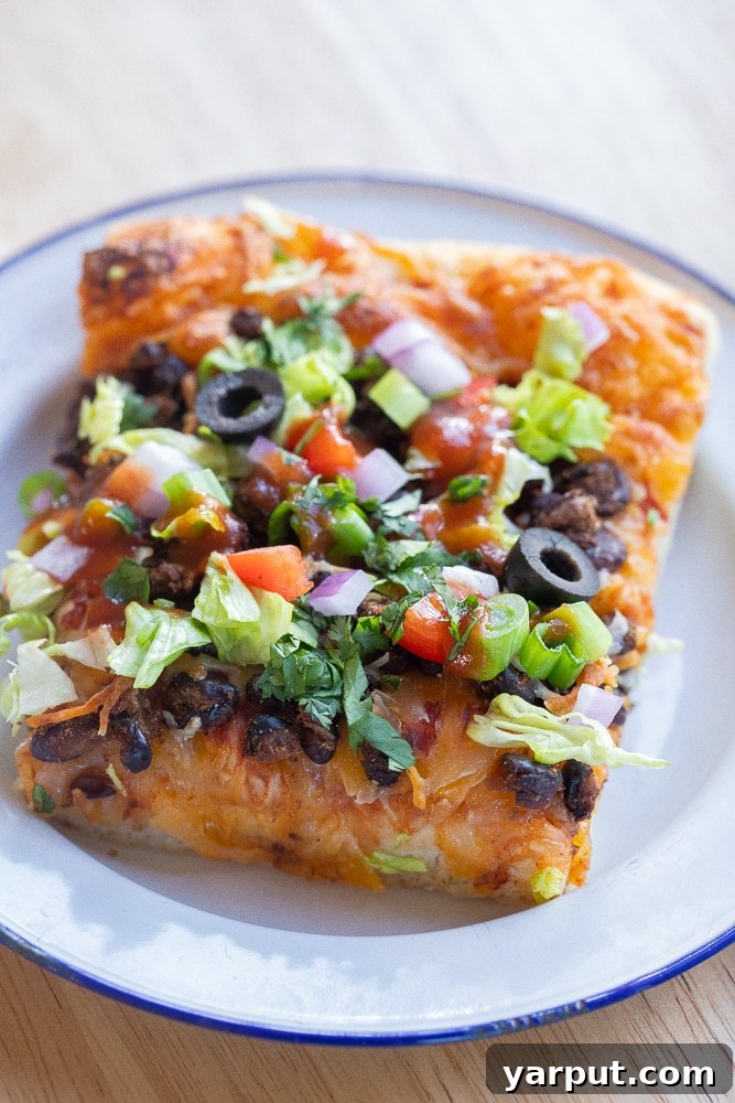 Savor the Crunch: Vegetarian Taco Pizza with Crispy Black Beans 7 close up of a slice of vegetarian taco pizza on a plate
