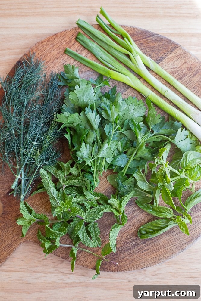 Fresh herbs on a cutting board for the green goddess dressing