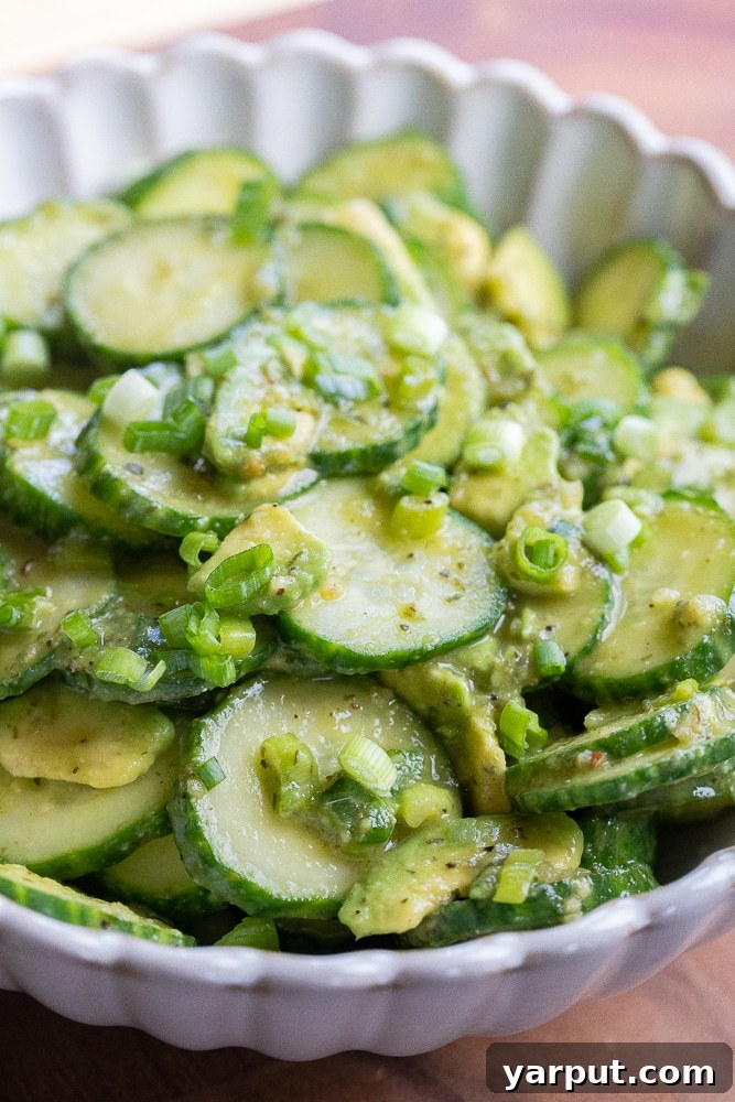 Zesty Avocado Cucumber Crunch Salad 6 Close-up photo of a fresh and vibrant bowl of avocado cucumber salad, highlighting the creamy avocado and crisp cucumber slices.