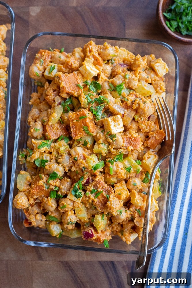 Spicy Buffalo Sweet Potato & Chickpea Power Bowls 2 A vibrant Buffalo Sweet Potato Chickpea Bowl in a meal prep container, ready for a healthy lunch.
