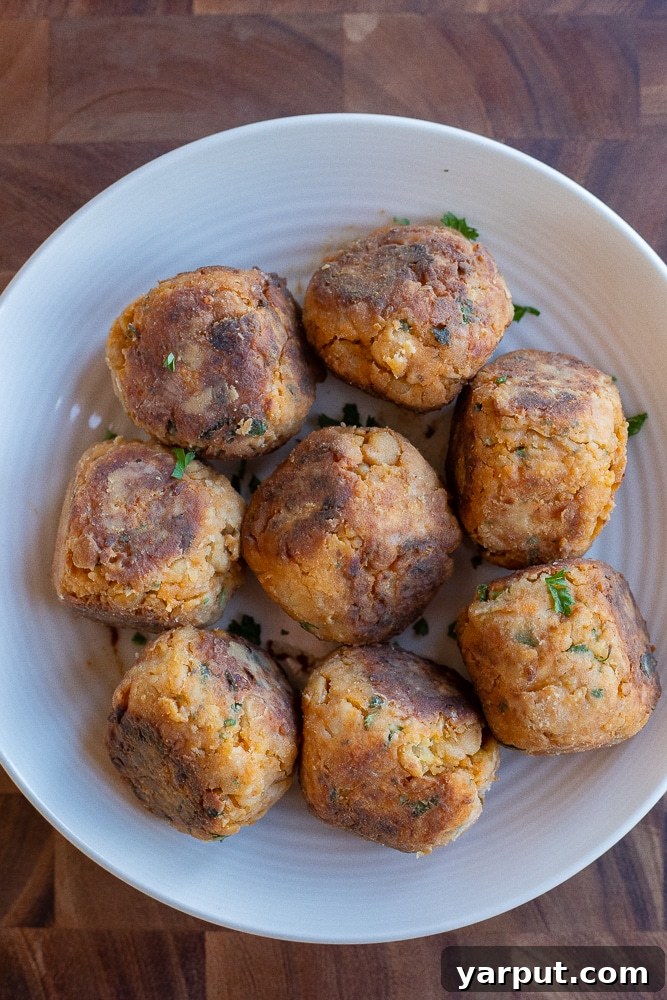 Effortless Veggie Meatballs 6 A generous serving of easy vegetarian meatballs nestled in a bowl, showcasing their golden-brown exterior and appealing texture.