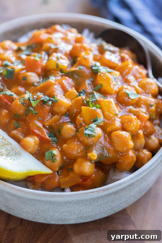 Creamy Pumpkin Red Curry with Chickpeas & Veggies 7 A beautifully composed close-up shot of the plant-based red pumpkin curry with chickpeas and colorful vegetables, emphasizing its rich texture and appetizing appeal.
