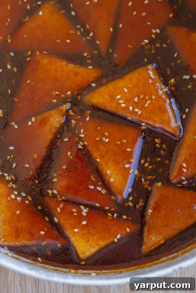 Effortless Glazed Teriyaki Tofu 6 Plated teriyaki tofu with rice, sesame seeds, and green onions