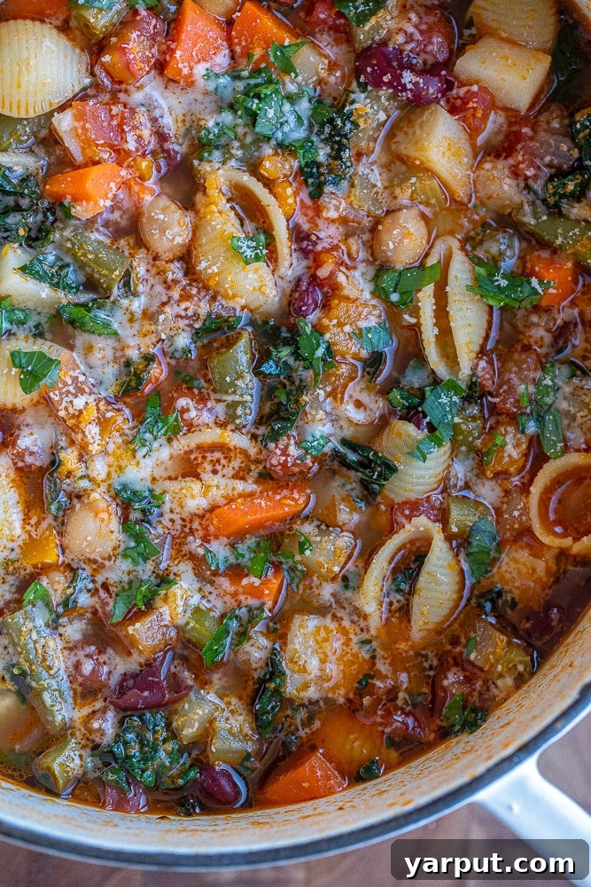 Hearty Minestrone Soup 6 close up of minestrone soup in a pot topped with parmesan cheese