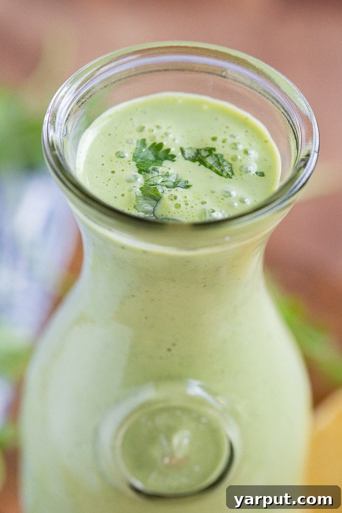Vibrant Herb Yogurt Dressing 7 close up of green herbed yogurt dressing in a glass serving jar