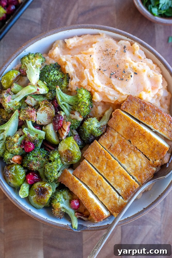 Harvest Veggie Thanksgiving Bowls 6 A close-up of a finished Vegetarian Thanksgiving Bowl with tofu, roasted vegetables, and mashed potatoes, ready to be enjoyed.
