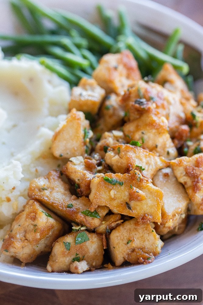 Close up of browned butter garlic tofu in a bowl, showcasing its golden texture
