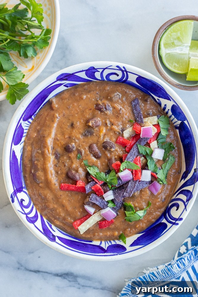 A World of Lentil Chickpea and Bean Delights 7 A hearty bowl of smoky black bean and sweet potato soup, garnished with a dollop of sour cream or avocado.