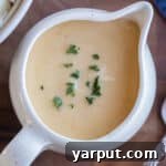 A small bowl of creamy vegetarian gravy