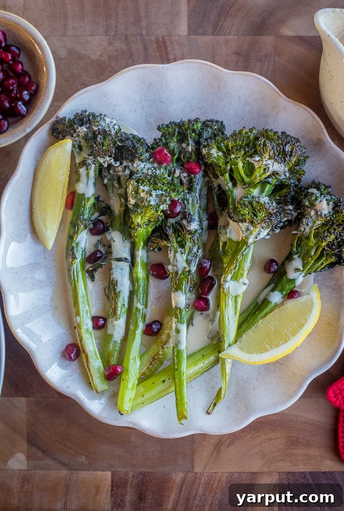 Zesty Lemon Tahini Roasted Broccolini 6 A beautifully arranged serving platter overflowing with golden-brown roasted broccolini, elegantly topped with a generous drizzle of lemon tahini dressing.