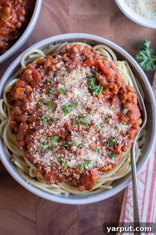 Effortless Vegetarian Meals for Week 16 6 Spaghetti topped with a rich, meaty lentil sauce, garnished with fresh basil, showcasing a hearty vegetarian pasta dish.