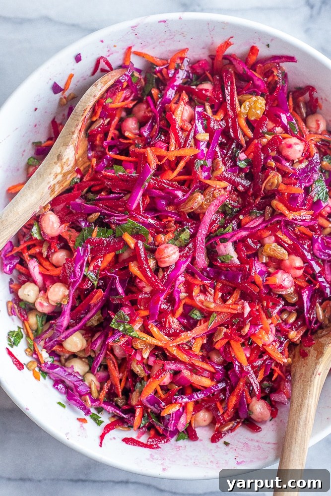 40+ Festive Vegetarian Side Dishes 14 A colorful beet and carrot salad with chickpeas, presented in a bowl to highlight its vibrant ingredients.