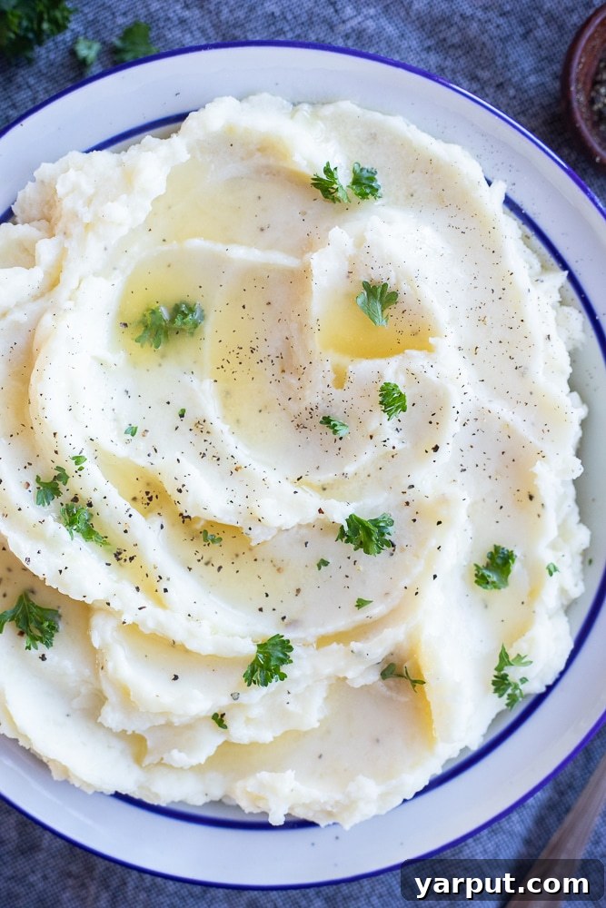 40+ Festive Vegetarian Side Dishes 24 Creamy garlic herb butter mashed potatoes, served in a bowl and garnished with fresh herbs.