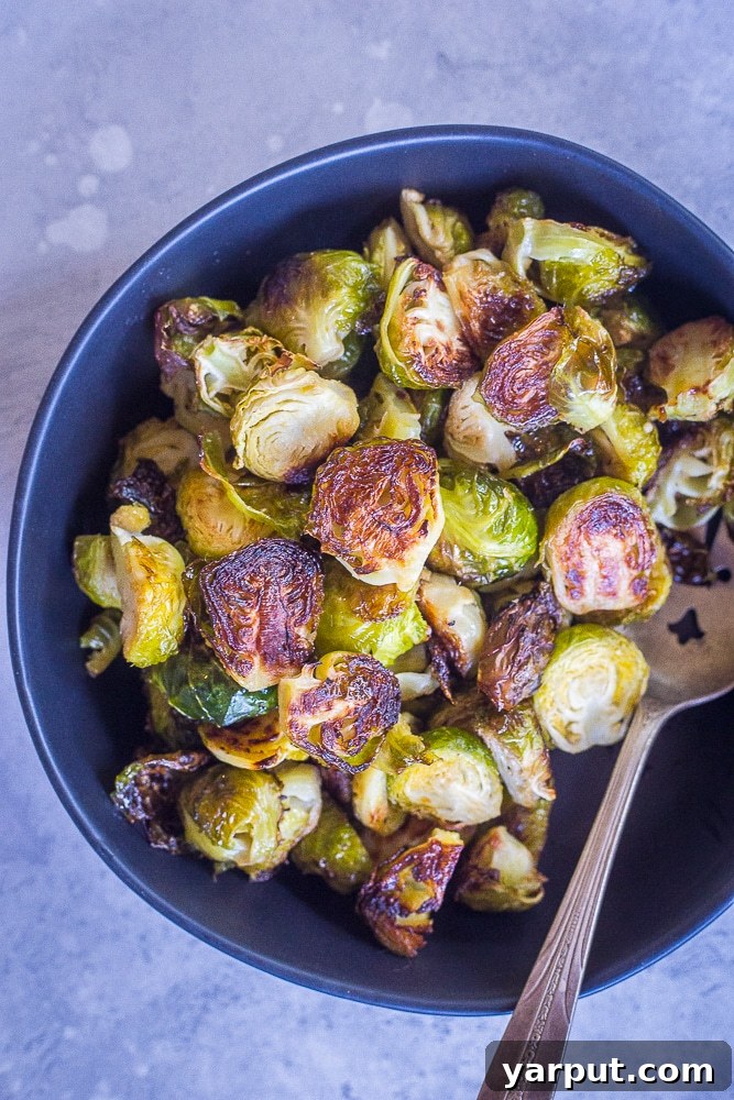 40+ Festive Vegetarian Side Dishes 42 Simple roasted Brussels sprouts, perfectly charred and seasoned, in a rustic bowl.
