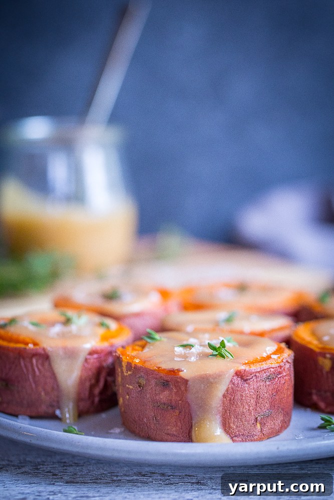 40+ Festive Vegetarian Side Dishes 43 Roasted sweet potatoes, glistening with tahini maple butter, served on a plate.