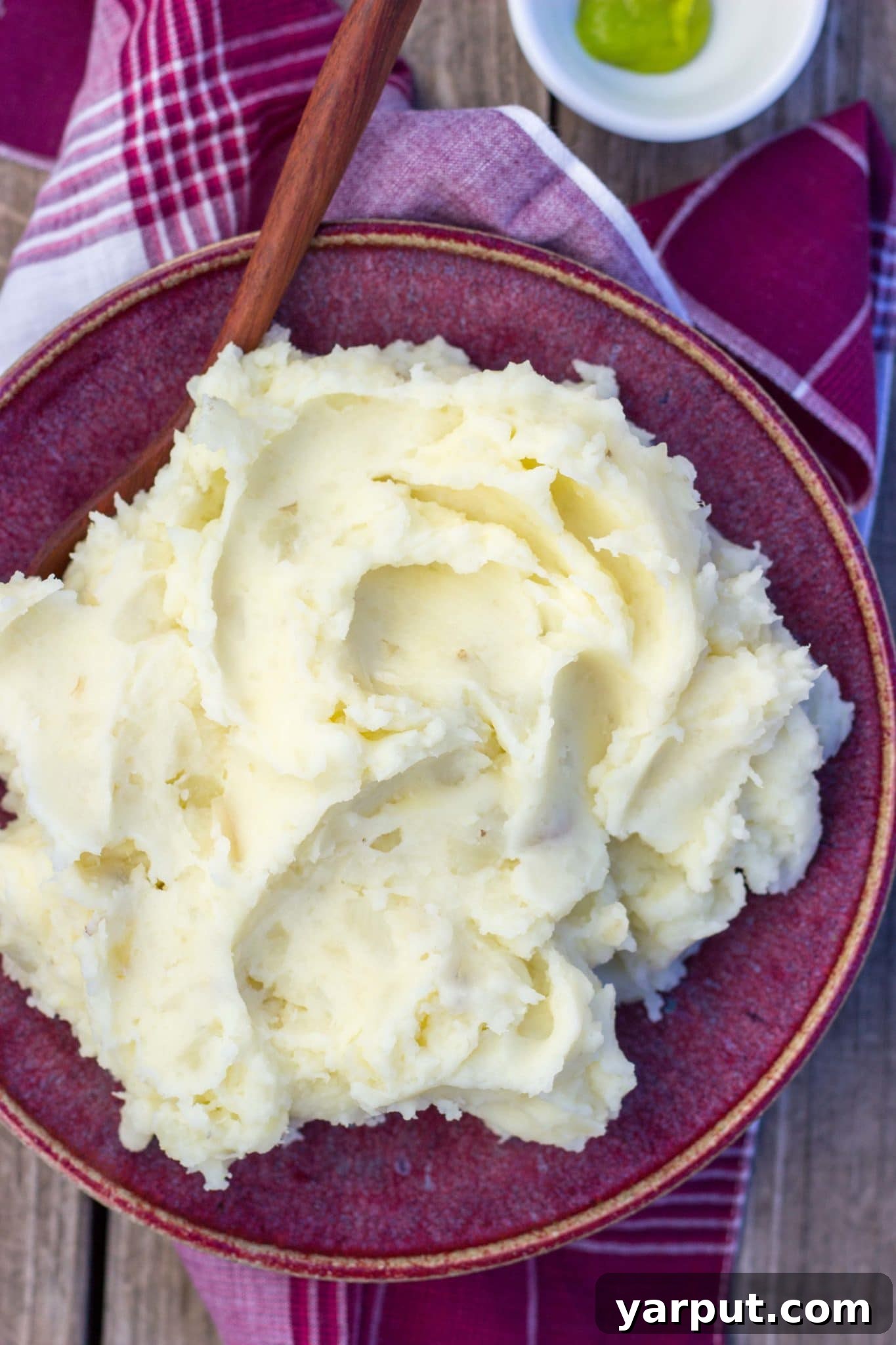 40+ Festive Vegetarian Side Dishes 45 Creamy Parmesan Wasabi Mashed Potatoes, with a hint of green, served in a white bowl.