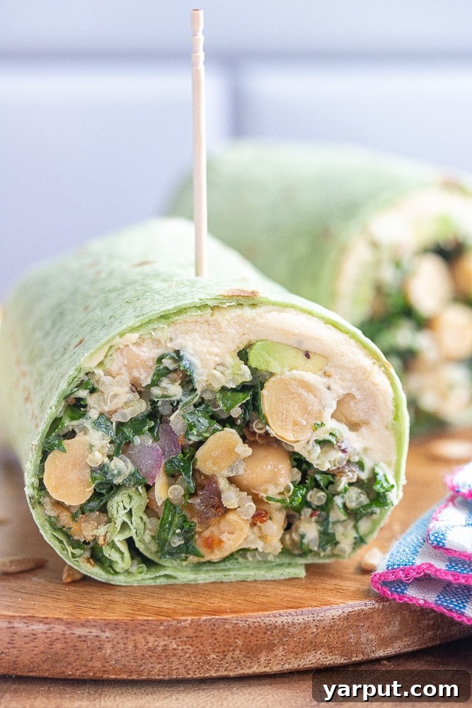 Plant-Powered Superfood Wraps 7 Close up shot of a freshly cut superfood wrap resting on a rustic cutting board, showcasing its enticing layers.