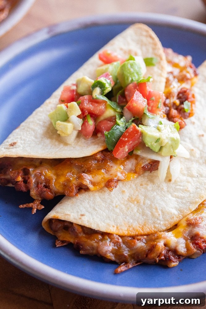 Plant-Powered 2026: Week 2 Meal Plan 4 Cheesy baked lentil tacos filled with seasoned lentils and melted cheese, ready to be served.