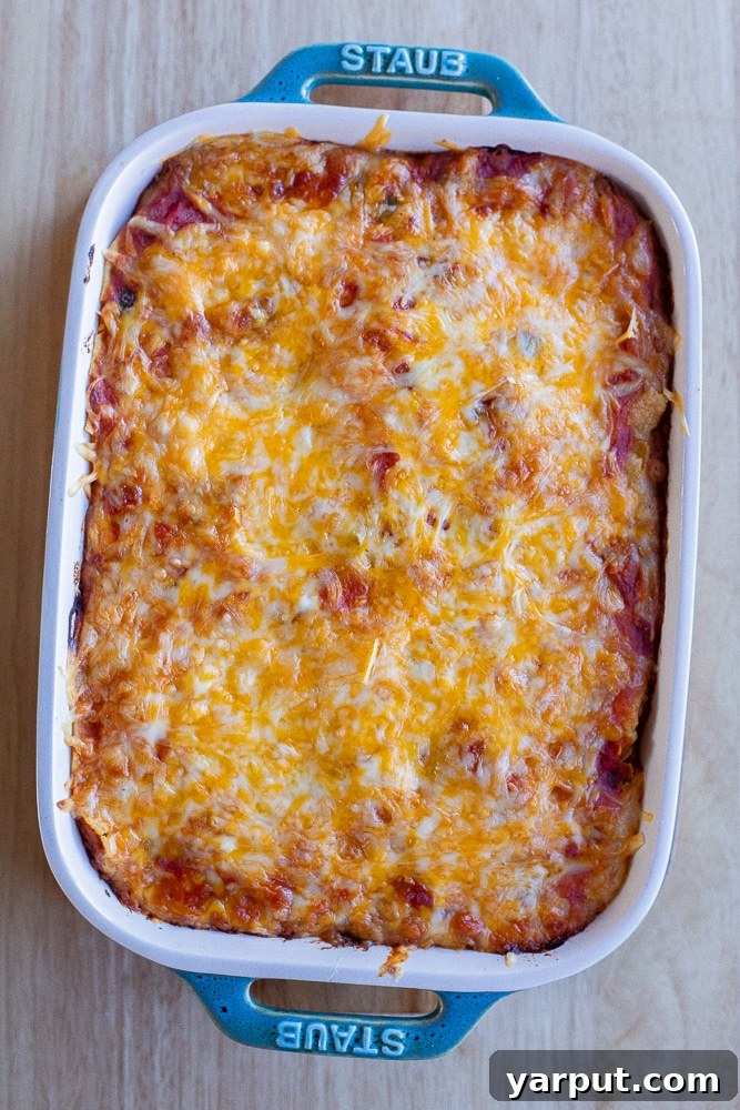 A slice of the 4-ingredient vegetarian taco bake on a plate with toppings