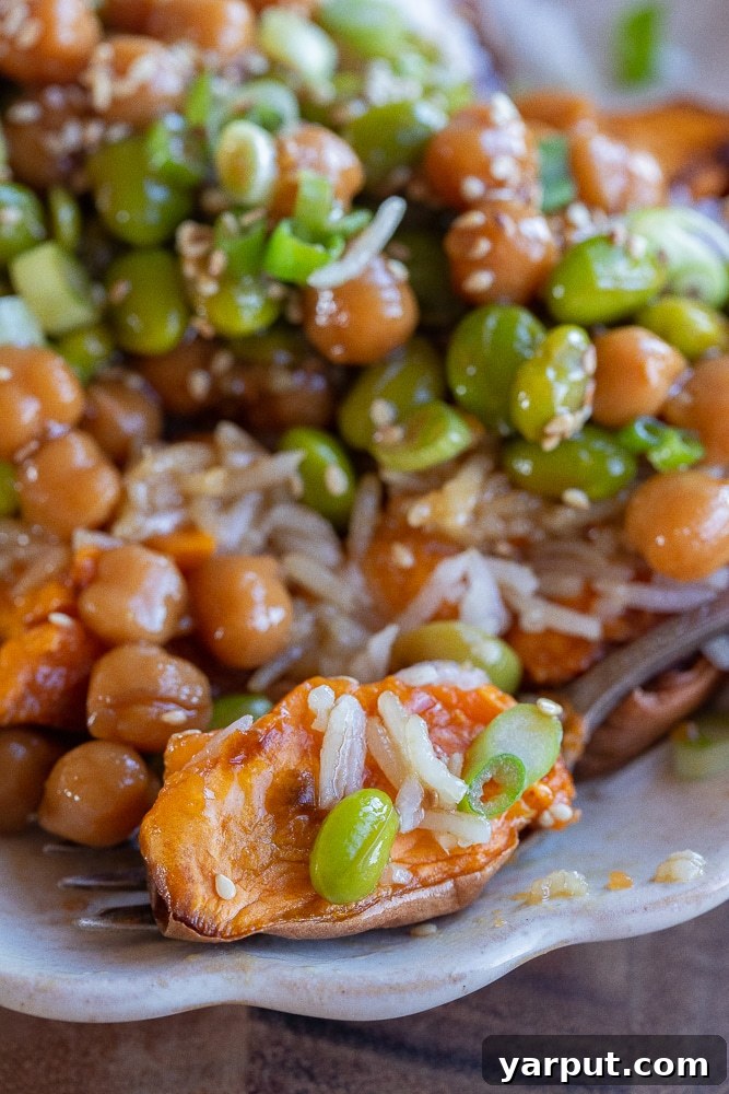 Loaded Teriyaki Edamame Sweet Potatoes 7 close up of a slice of sweet potato on a fork with edamame and rice