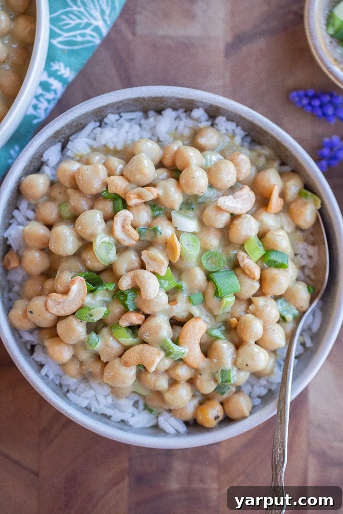 Fragrant Green Curry Chickpeas in Minutes 7 A serving bowl filled with vegan green curry chickpeas, garnished and ready to eat.