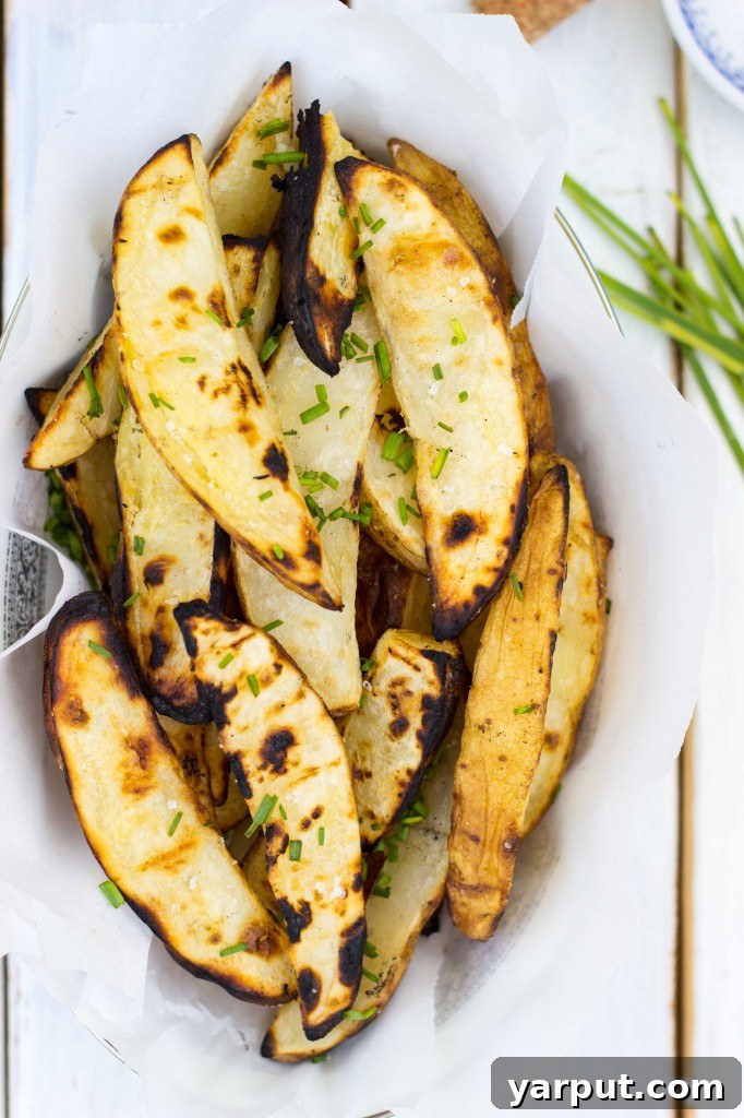 Zesty Salt and Vinegar Char-Grilled Potato Wedges 12 Close-up of crispy, golden-brown grilled potato wedges.