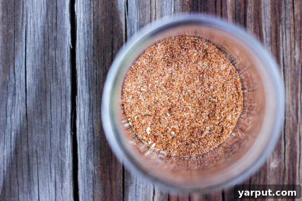 A vibrant table setting with BBQ Cauliflower and Chickpea Tacos, fresh ingredients, and a bowl of creamy lime slaw.