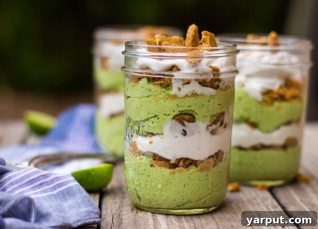Table spread with multiple Lime Cheesecake Parfaits and fresh limes