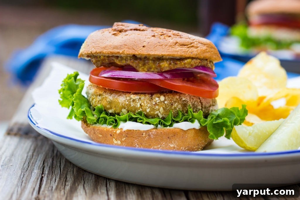 Several vegan chicken patty sandwiches arranged on a wooden board