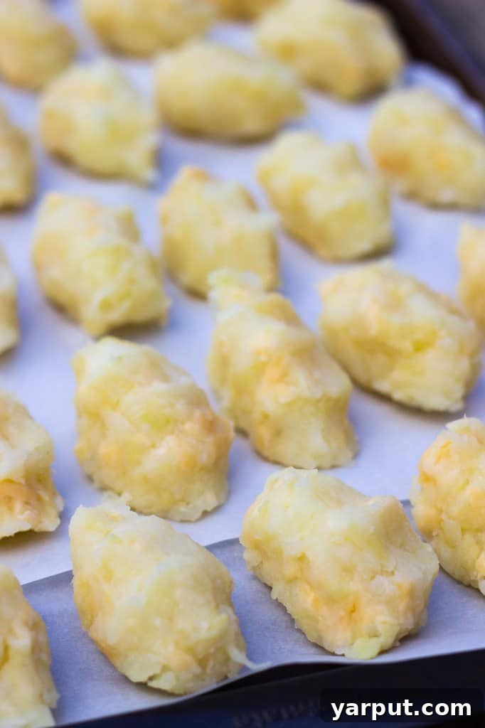 Ingredients for baked tater tots with smoked gouda and green apple, including grated potatoes and apples