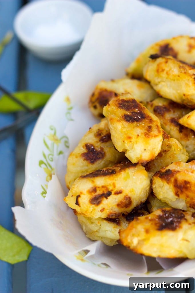 Baked Tater Tots with Smoked Gouda and Green Apple on a plate with cutlery