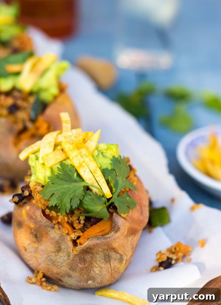Fiesta Sweet Potato Boats 12 A hand reaching for a Tex-Mex Loaded Sweet Potato