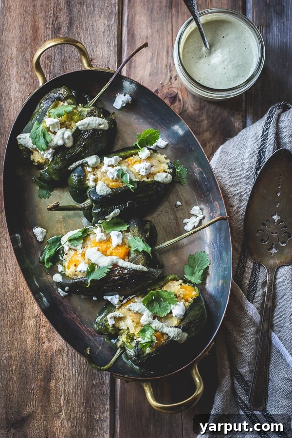 Stuffed Poblano Chiles Roasted Poblano Chiles stuffed with Cheesy Butternut Squash Quinoa and Pepita Crema