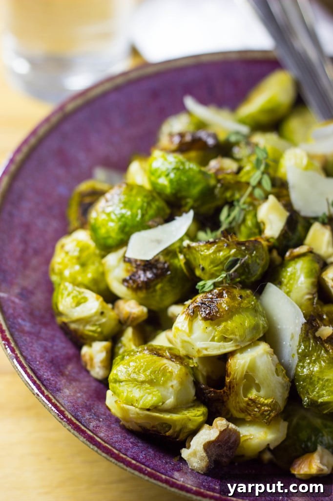 Sweet & Tangy Roasted Brussels Sprouts with Toasted Walnuts and Parmesan 7 Overhead shot of Maple & Dijon Roasted Brussels Sprouts with cheese and walnuts