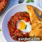Close-up of Eggs in Purgatory with Spaghetti Squash, showing rich tomato sauce and a runny yolk.