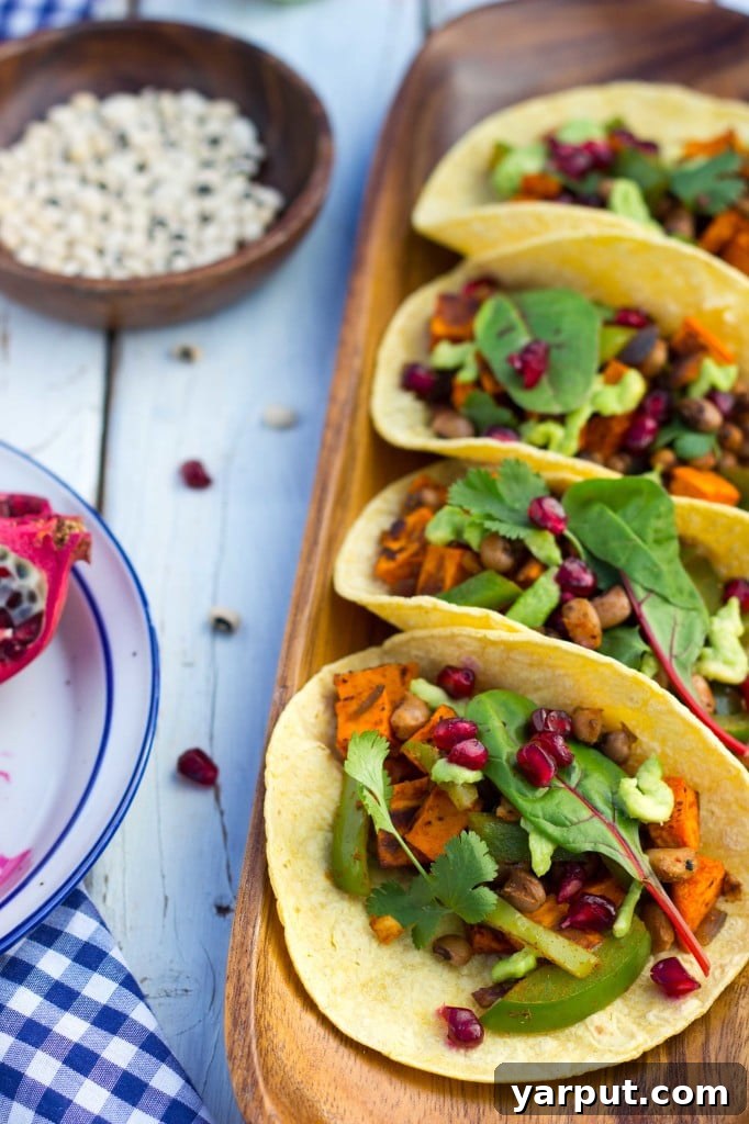Overhead shot of Black Eyed Pea and Sweet Potato Tacos with fresh garnishes